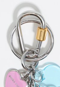 Silver metal keychain with a gold accent, featuring pink and blue heart-shaped plastic charms. Appears shiny with smooth surfaces.