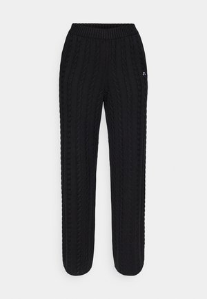 Pantalones de punto negros con una textura acanalada y detalles en cable vertical. La cinturilla elástica ofrece comodidad y un ajuste ajustable.