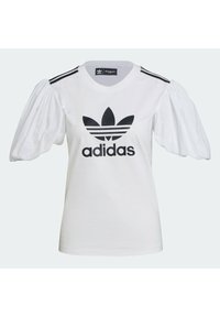 Camiseta blanca con el logo negro de Adidas, con mangas abullonadas y tres franjas negras en los hombros. Fabricada en suave algodón con textura lisa.