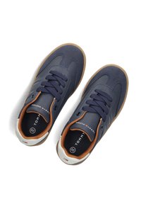Sneaker blu navy con tomaia in sintetico texturizzato, punta tonda e chiusura con lacci. Presenta dettagli marroni, soletta imbottita e suola in gomma.