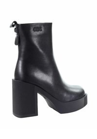 Czarny skórzany botek sięgający kostki z okrągłym noskiem, zapinany na zamek błyskawiczny, z grubym, żebrowanym obcasem blokowym dla większej wysokości i stabilności.