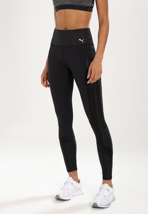 Leggings sportivi neri con vita alta, realizzati in tessuto liscio. Presentano pannelli in rete e un design elegante e aderente.
