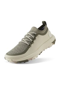 Leichtgewichtiger Sneaker in Beige und Olivgrün, mit strukturiertem Obermaterial, runden Schnürsenkeln und einer dicken, unterstützenden Sohle mit Traktionsmustern.