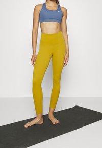 Nike Performance Leggings - dark yellow
