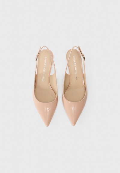 Nude patent leather slingback heels with a pointed toe, thin ankle strap, and textured insole. Brand logo printed on the footbed.