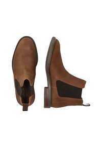 Brune ruskinds Chelsea-støvler med elastiske sidepaneler, trækstrop og gummisåler. Har kontrastsyninger og en glat overflade.