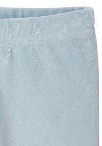 Light blue terry cloth pant hem with an elastic waistband. Soft texture with vertical ribbing detail. Minimalist design.