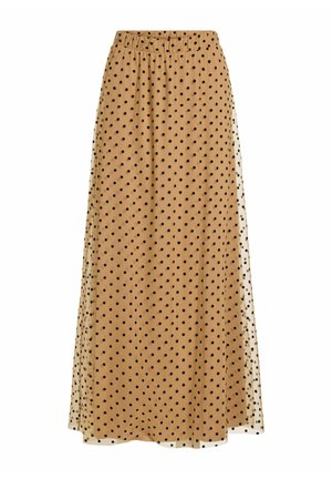 Longue jupe beige à pois noirs avec une taille élastique, présentant une superposition transparente.