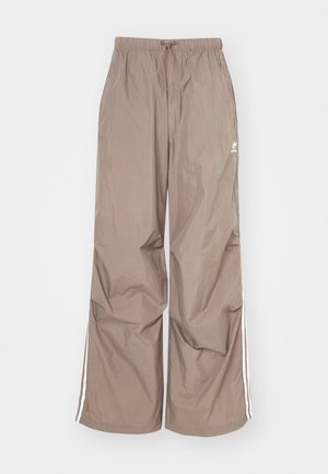 Brune, løstsiddende bukser fremstillet af letvægtsmateriale, med hvide sideloser og en elastisk talje med snøring.