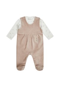 Rosenholzfarbene Corduroy-Trägerhose mit gerippter Textur, die ein enganliegendes Oberteil und eine Katzenstickerei aufweist. Darunter ein langärmliges weißes Hemd mit Blumenmuster.