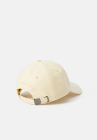 Yellow cotton baseball cap with a curved brim, adjustable strap at the back, and subtle branding embroidered on the side.
