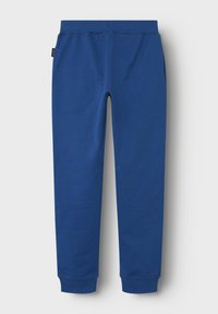 Pantalon de survêtement bleu en mélange de coton doux, avec une taille élastique, des jambes fuselées et des poches latérales pour plus de fonctionnalité.