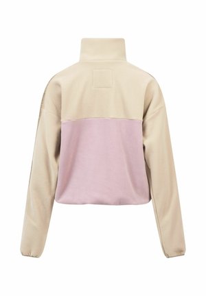 Fleece-Jacke mit hohem Kragen, beige Oberteil und hellrosa Unterpaneel. Weicher Stoff mit lockerer Passform und langen Ärmeln.