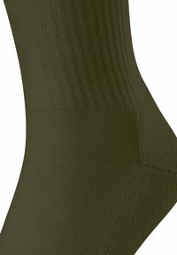 Calzino verde oliva con texture a coste, forma aderente e tallone rinforzato. Il materiale appare liscio ed elastico per il comfort.