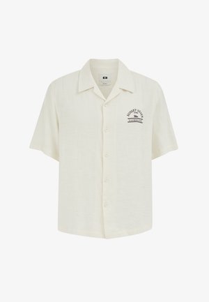 Rövid ujjú krémszínű gombos ing gallérral, bal mellrészen fekete "Sunset State Clubhouse" felirattal.