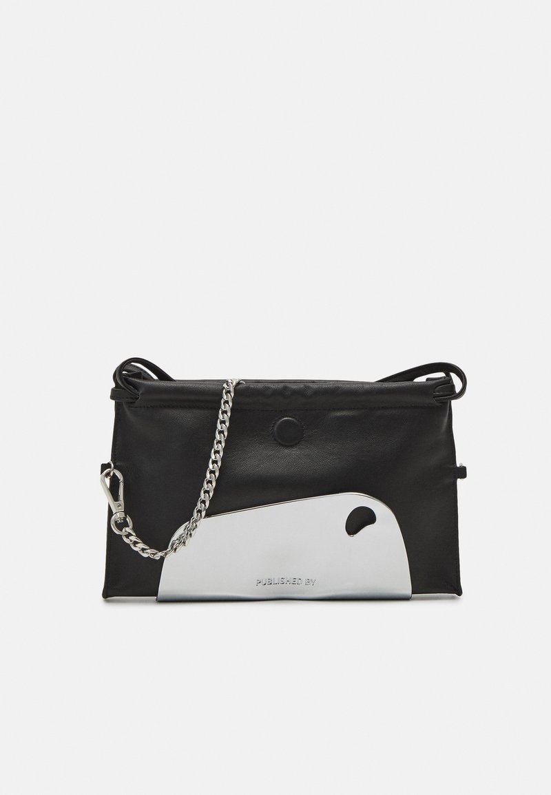 Black leather bag with a silver metal accent, featuring a chain strap and a snap closure. Structured shape with a smooth texture.