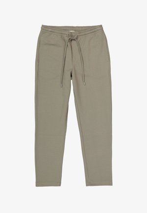 Pantalones de chándal beige claros hechos de una tela suave, con una cinturilla elástica y cordones, y piernas ajustadas. Diseño minimalista, sin estampados.