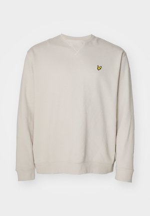 Sudadera de color beige claro con mangas largas, cuello redondo y un pequeño logo bordado amarillo en el lado izquierdo del pecho. Fabricada en tejido suave.