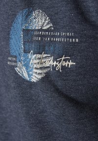 Dark blue T-shirt featuring a round graphic with a leaf design in blue and white, and embroidered text in light gray and white.