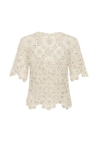 Blouse en dentelle à manches courtes de couleur crème avec motifs floraux découpés et petits sequins, bords festonnés aux manches et à l'ourlet.