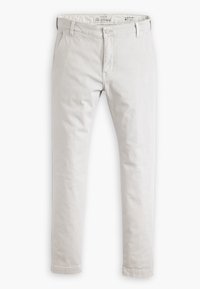 Light beige slim taper chinos with belt loops, button closure, and side pockets, laid flat on white background.