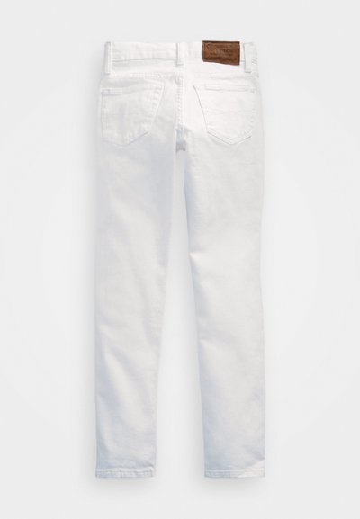 White denim jeans with a straight leg cut, five-pocket design, and a brown leather patch on the back waistband. Smooth texture.