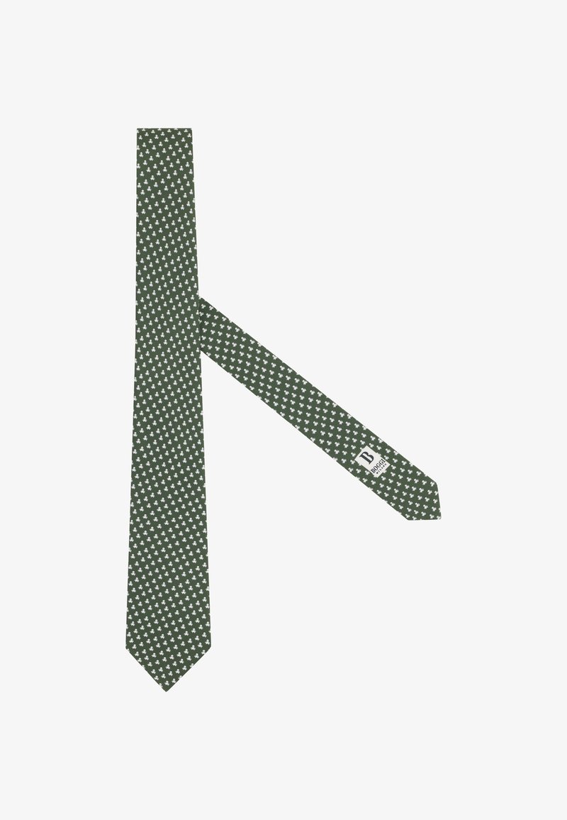 Cravate vert foncé avec un petit motif de fleurs de lys blanches, posée à plat avec l'étiquette visible sur l'extrémité étroite.