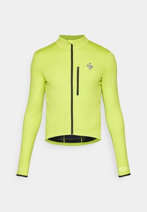 Giacca da ciclismo a maniche lunghe di un vivace verde lime, con zip frontale, una piccola tasca sul petto e dettagli neri sui polsini e sull'orlo.