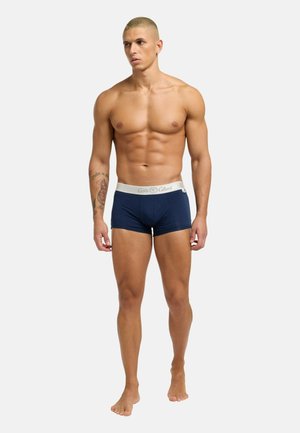 Marinefarbene Boxershorts aus weichem elastischem Material mit weißem Bündchen. Der Stoff wirkt glatt und enganliegend und betont die Körperform. Keine sichtbaren Muster.