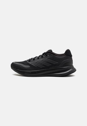 Scarpe da ginnastica nere realizzate in mesh e materiali sintetici, con punta rotonda, suola spessa e un distintivo design a tre strisce.