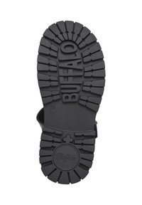 Semelle de chaussure en caoutchouc noir avec un profond motif de bande de roulement. Présente le mot « BUFFALO » en relief au centre ainsi qu'un logo circulaire. Taille indiquée : 38.