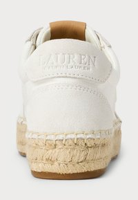 White sneaker with a suede upper, rope detailing around the sole, and embossed logo at the heel. Brown leather accent on the top.