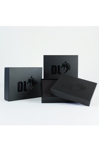Black cardboard gift boxes of varying sizes, featuring a glossy finish and embossed dragon logo with "DL" in bold lettering.