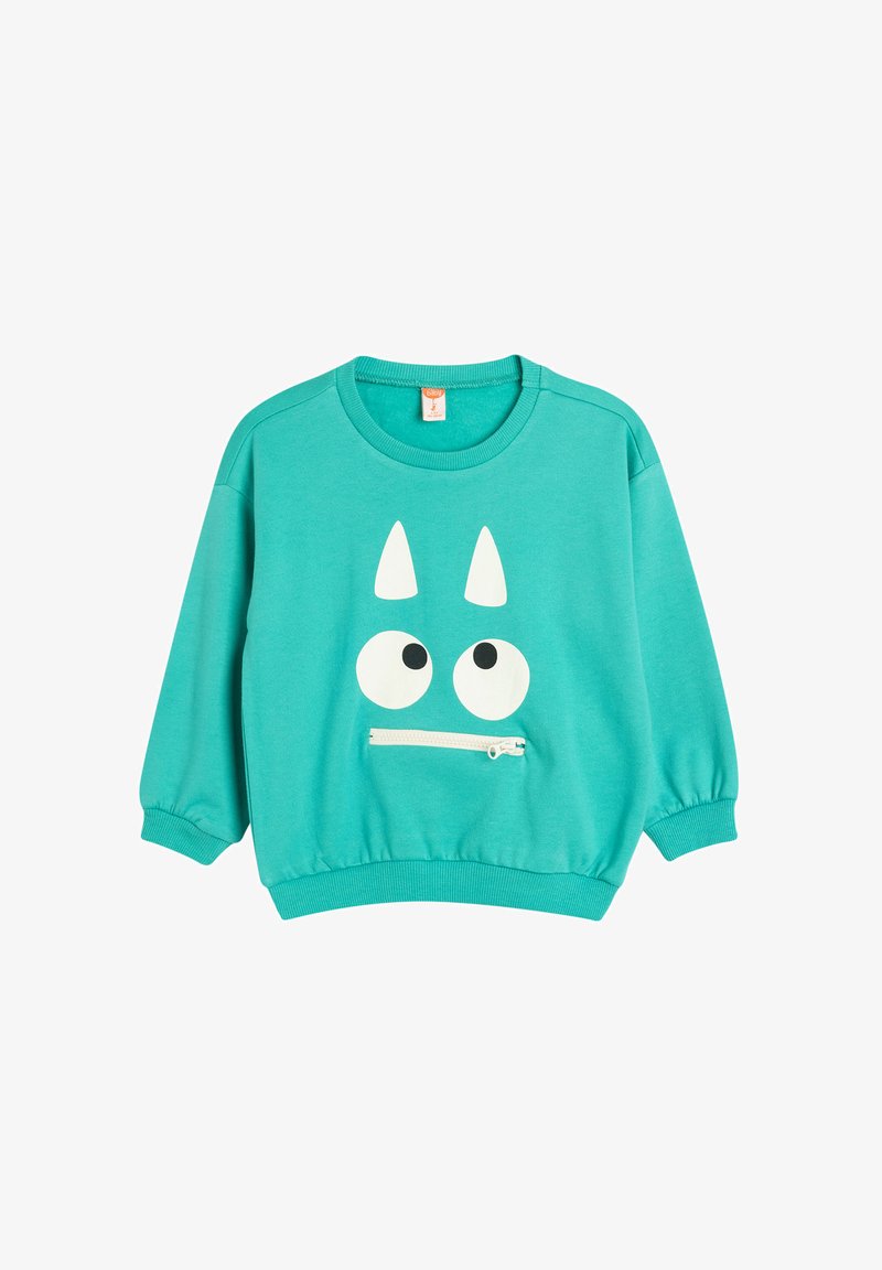Felpa turchese con collo rotondo, maniche lunghe e design di un volto con occhi bianchi e corna. Include una tasca frontale con zip.