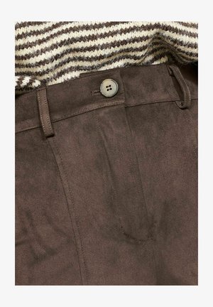 Brown suede-like pants with a smooth texture, featuring a front button and belt loops, partially covered by a striped knit sweater.