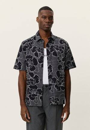 Schwarzes Kurzarmhemd mit weißen Blumenmustern, durchgehender Knopfleiste und legerer Passform. Glatte Textur mit feinen Streifen.