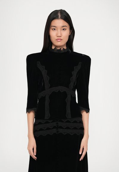 Black velvet dress with lace trim, high collar, three-quarter sleeves, and intricate patterns. Features textured accents and button details.