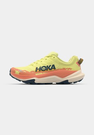 Running shoe with a bright yellow mesh upper, orange midsole, blue outsole, and prominent black logo. Textured surface and vibrant color accents.