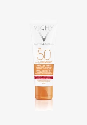 Vichy Capital Soleil SPF 50 cream in a white tube with orange accents. Front label displays SPF, anti-aging claims, and volume (50 ml).