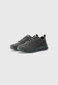 Black athletic shoes with mesh upper, rounded toe, and textured sole. Features laces, pull tab, and side pattern. Lightweight design.