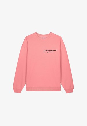 Felpa rosa con maniche lunghe, polsini e orlo a coste. Presenta un testo in corsivo nero "segui il tuo cuore" con una grafica a freccia sul davanti.