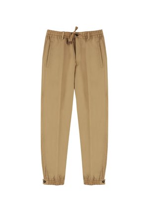 Pantalons beige courts en tissu lisse, avec une taille élastique et un cordon de serrage, des poches latérales et des chevilles fuselées agrémentées de boutons.