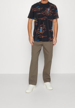 Schwarzes T-Shirt mit kurzen Ärmeln und buntem Muster aus Meerestieren; kombiniert mit olivgrünen Hosen und weißen Turnschuhen. Lässiger Schnitt und Design.