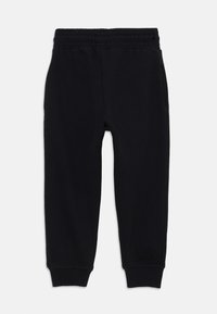 Schwarze Sweatpants aus einem Baumwollmix, mit einem elastischen Bund, seitlichen Taschen und gerippten Bündchen an den Knöcheln.