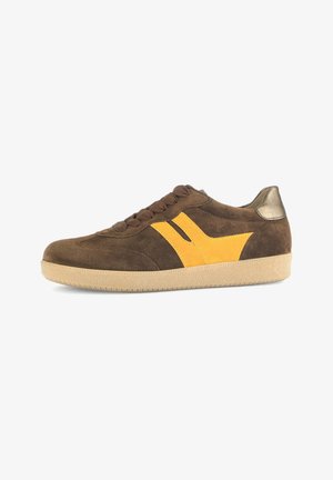 Brown suede sneaker with a yellow suede accent, textured surface, round toe, and tan rubber sole. Features brown laces and a metallic heel detail.