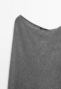 Gray ribbed knit fabric with a boat neckline, showing a clothing label partially visible inside the collar.