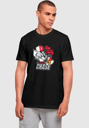 Black cotton t-shirt featuring a animated graphic of Tom and Jerry, with text "Tom and Jerry CHASE" in red and white font. Short sleeves.