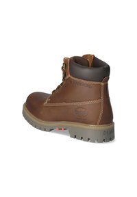 Bota de cuero marrón hasta el tobillo con un cuello acolchado, puntera redonda y suela de goma gris. Presenta costuras en contraste y detalle de logo en relieve.