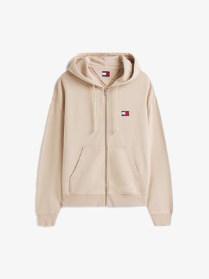 Bež kapuutsiga jope, mis on valmistatud puuvilla segakangast. Omab suurt esistaskut, soonikuga mansette ning logo plaastrit rinnal. Kapuutsiga disain.