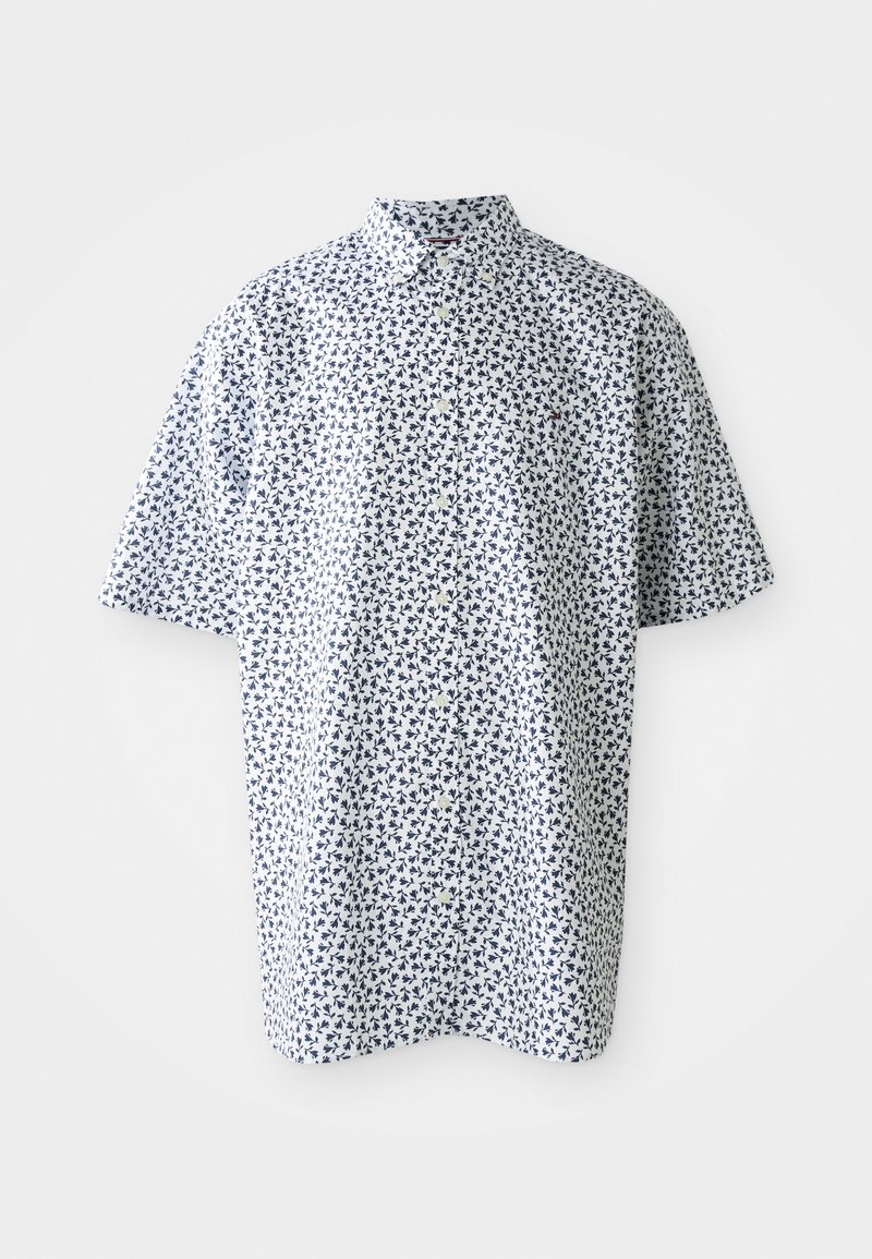 Chemise blanche à manches courtes avec un petit motif floral bleu marine et un col classique, présentée sur un fond uni.